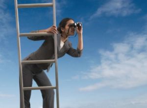 Women on a ladder looking around with binoculars, sky background 